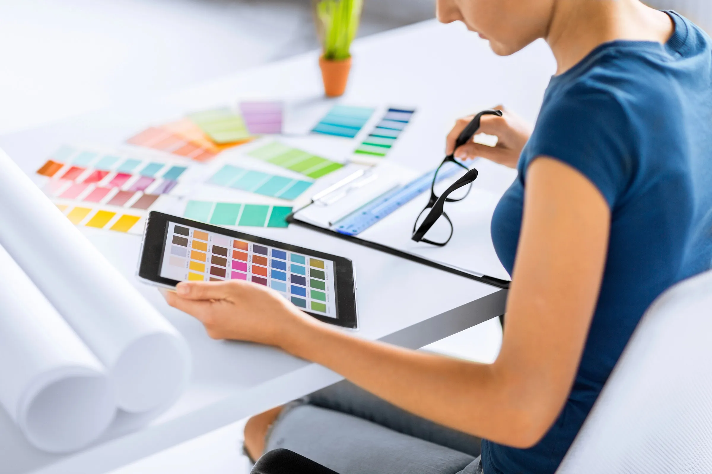 Female designer at her desk choosing from swatches of colour