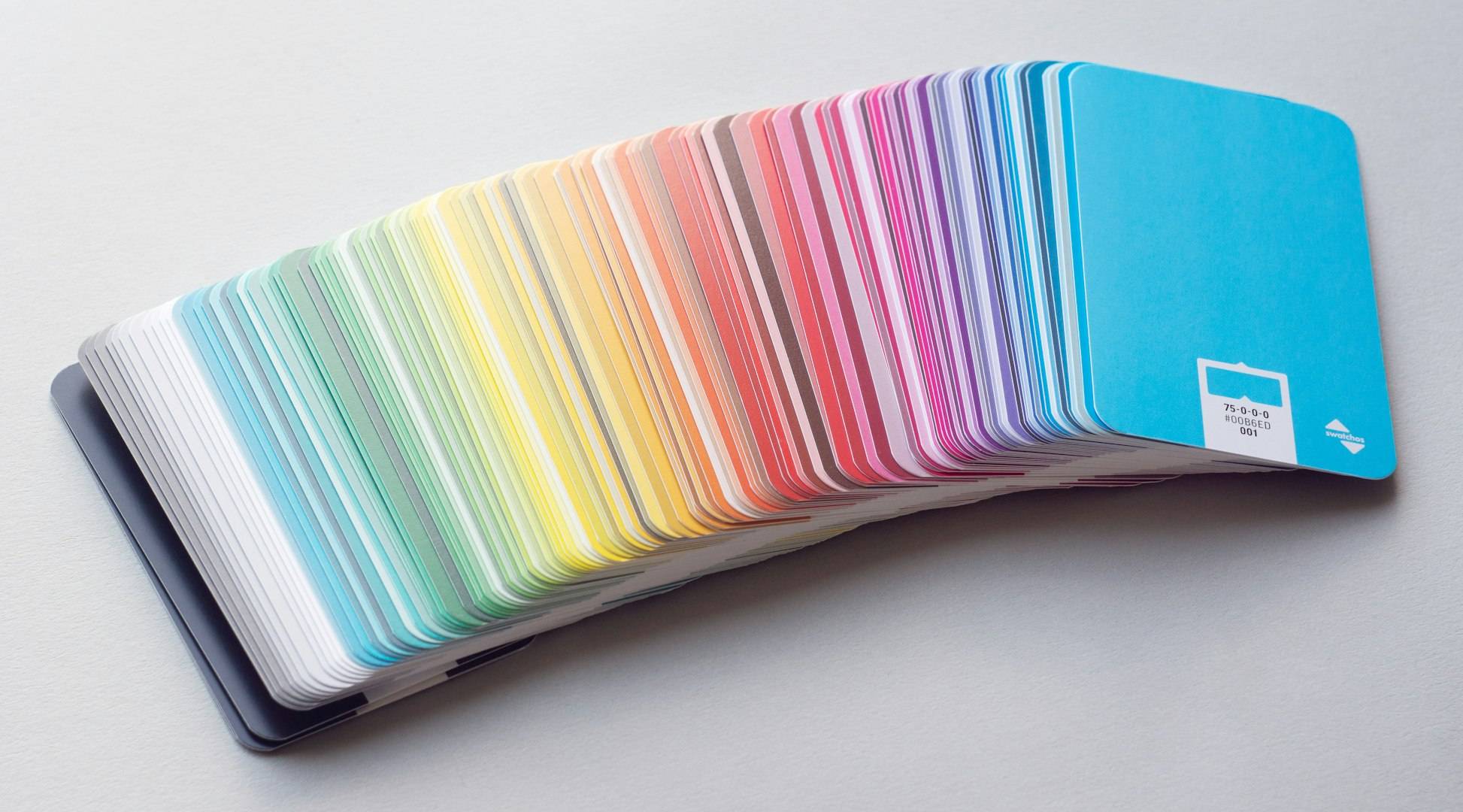 Coloured swatch cards spread out to make a rainbow of colours